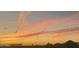Beautiful sunrise over palm trees and silhouetted mountains at 10794 S Coolwater Dr, Goodyear, AZ 85338