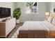 Well-lit bedroom with a window view, dresser, and light-colored walls at 1105 W Anderson Dr, Phoenix, AZ 85023