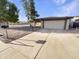 Single-story home with a two-car garage and a low-maintenance desert landscape at 1105 W Anderson Dr, Phoenix, AZ 85023