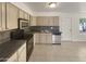 Kitchen featuring stainless steel appliances, ample cabinet space, and tile flooring at 1105 W Anderson Dr, Phoenix, AZ 85023