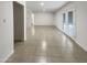 Open living room showcasing neutral color scheme, tile flooring, and access to the backyard through glass doors at 1105 W Anderson Dr, Phoenix, AZ 85023
