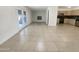 Spacious living room with tile floors connecting to the kitchen and french doors to the backyard at 1105 W Anderson Dr, Phoenix, AZ 85023