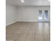 Bright, open living room with neutral tile flooring and sliding glass doors to the backyard at 1105 W Anderson Dr, Phoenix, AZ 85023