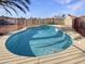 Backyard pool with a desert landscape and enclosed with a mesh fence for safety at 1105 W Anderson Dr, Phoenix, AZ 85023