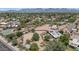 Aerial view of the neighborhood showcasing the lush landscaping, the many houses and the mountain backdrop at 12682 N 80Th Pl, Scottsdale, AZ 85260