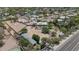 Stunning aerial view of a property featuring a pool, mature trees, and solar panels on the roof at 12682 N 80Th Pl, Scottsdale, AZ 85260