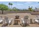 Expansive backyard featuring desert landscaping, a charming fire pit, and comfortable Adirondack seating at 12682 N 80Th Pl, Scottsdale, AZ 85260