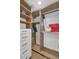 Walk-in closet with wooden shelves, white drawers, and a variety of storage options at 12682 N 80Th Pl, Scottsdale, AZ 85260