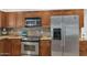 Kitchen features stainless steel appliances, wooden cabinetry, and granite countertops at 12682 N 80Th Pl, Scottsdale, AZ 85260