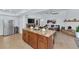 Open-concept living room with a kitchen island, a cozy fireplace, and modern decor at 12682 N 80Th Pl, Scottsdale, AZ 85260