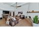 Spacious living room featuring leather sofas, a fireplace, and a comfortable seating arrangement at 12682 N 80Th Pl, Scottsdale, AZ 85260
