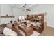 Open-concept living room with a fireplace, leather couches, and seamless kitchen access at 12682 N 80Th Pl, Scottsdale, AZ 85260