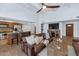 Open living room featuring a leather sofa, ceiling fan, and seamless flow to the kitchen at 12682 N 80Th Pl, Scottsdale, AZ 85260