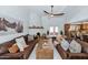 Large living room with beamed ceilings, a fireplace, and comfortable leather furniture at 12682 N 80Th Pl, Scottsdale, AZ 85260
