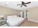Spacious main bedroom featuring neutral decor, tile floors, ceiling fan, and ensuite bath at 12682 N 80Th Pl, Scottsdale, AZ 85260