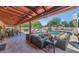 Covered patio with comfortable seating and lights overlooking the outdoor pool area for entertaining guests at 12682 N 80Th Pl, Scottsdale, AZ 85260