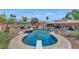 Resort style pool with mature landscaping surrounding the perimeter, in addition to seating area for relaxing at 12682 N 80Th Pl, Scottsdale, AZ 85260