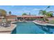 Beautiful backyard showcasing a sparkling pool, lounge seating, and lush landscaping at 12682 N 80Th Pl, Scottsdale, AZ 85260