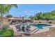 Resort style pool with a spa and steps leading to the water and seating area for relaxing and enjoying the weather at 12682 N 80Th Pl, Scottsdale, AZ 85260