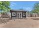 View of the backyard shed, offering ample storage space, and the surrounding desert landscape at 12682 N 80Th Pl, Scottsdale, AZ 85260