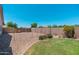Low-maintenance backyard with gravel landscaping, a small lawn, and block wall fencing at 13034 W Krall Ct, Glendale, AZ 85307
