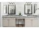 Bathroom featuring granite counters, double sinks, vanity, and decorative mirrors at 13034 W Krall Ct, Glendale, AZ 85307