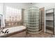 Bathroom showcasing a glass block shower, soaking tub, and neutral tile at 13034 W Krall Ct, Glendale, AZ 85307