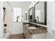 Bright bathroom features double sinks with granite counters, framed mirrors, and a tub with a shower at 13034 W Krall Ct, Glendale, AZ 85307