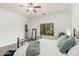Bedroom featuring a metal bedframe, a window with green trees, and white walls at 13034 W Krall Ct, Glendale, AZ 85307