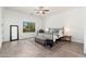 Bright bedroom with a decorative ceiling fan, metal bedframe, and a large window at 13034 W Krall Ct, Glendale, AZ 85307