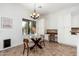 Bright dining area with a glass table, wooden chairs, and built-in desk area at 13034 W Krall Ct, Glendale, AZ 85307