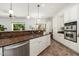Kitchen area with stainless steel appliances, granite countertops, and backyard view at 13034 W Krall Ct, Glendale, AZ 85307