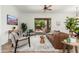 Comfortable living room with a brown leather sofa and sliding glass doors leading to the backyard at 13034 W Krall Ct, Glendale, AZ 85307