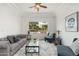 Comfortable living room featuring a gray sofa, patterned rug, and backyard view at 13034 W Krall Ct, Glendale, AZ 85307