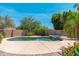 Well-maintained pool with rock features and patio, creating a perfect backyard retreat at 13034 W Krall Ct, Glendale, AZ 85307