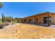 The spacious backyard features a covered patio, desert landscaping, and a statue, offering a tranquil retreat at 132 W Wood Dr, Phoenix, AZ 85029