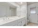Bright bathroom featuring a double sink vanity, and door to outdoor patio at 132 W Wood Dr, Phoenix, AZ 85029