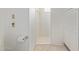 Well-lit bathroom features a walk-in shower with a marble base, and built-in linen closet at 132 W Wood Dr, Phoenix, AZ 85029