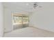 Light and airy bedroom featuring a ceiling fan, carpet, and sliding glass door at 132 W Wood Dr, Phoenix, AZ 85029