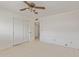 Neutral bedroom with carpet, ceiling fan, and double door closet at 132 W Wood Dr, Phoenix, AZ 85029