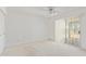 Light and airy bedroom featuring a ceiling fan, carpet, and large sliding glass door at 132 W Wood Dr, Phoenix, AZ 85029