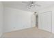 Bright bedroom with neutral carpet, ceiling fan, and double door closet at 132 W Wood Dr, Phoenix, AZ 85029