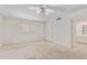 Bedroom features neutral carpeting, white walls, storage, large window, and bright natural light at 132 W Wood Dr, Phoenix, AZ 85029