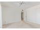 Bright bedroom with neutral carpet, ceiling fan, and double door closet at 132 W Wood Dr, Phoenix, AZ 85029