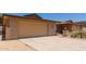 Attached two-car garage with driveway, complemented by desert landscaping and a gated front courtyard at 132 W Wood Dr, Phoenix, AZ 85029