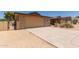 Attached two-car garage with driveway, complemented by desert landscaping and a gated front courtyard at 132 W Wood Dr, Phoenix, AZ 85029