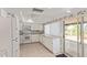 Functional kitchen with tile flooring, a breakfast bar, and a door leading to a patio at 132 W Wood Dr, Phoenix, AZ 85029