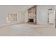 Living room showcasing a stone fireplace, large windows, neutral carpet, and a bright, open atmosphere at 132 W Wood Dr, Phoenix, AZ 85029