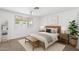 Bedroom featuring neutral carpet, large window, and tasteful decor at 1417 W Los Arboles Pl, Chandler, AZ 85224