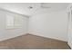 A bright bedroom with carpet, ceiling fan, and window with shutters at 1417 W Los Arboles Pl, Chandler, AZ 85224